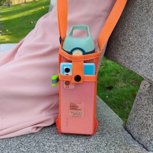 The water bottle is stored diagonally across the grid bag